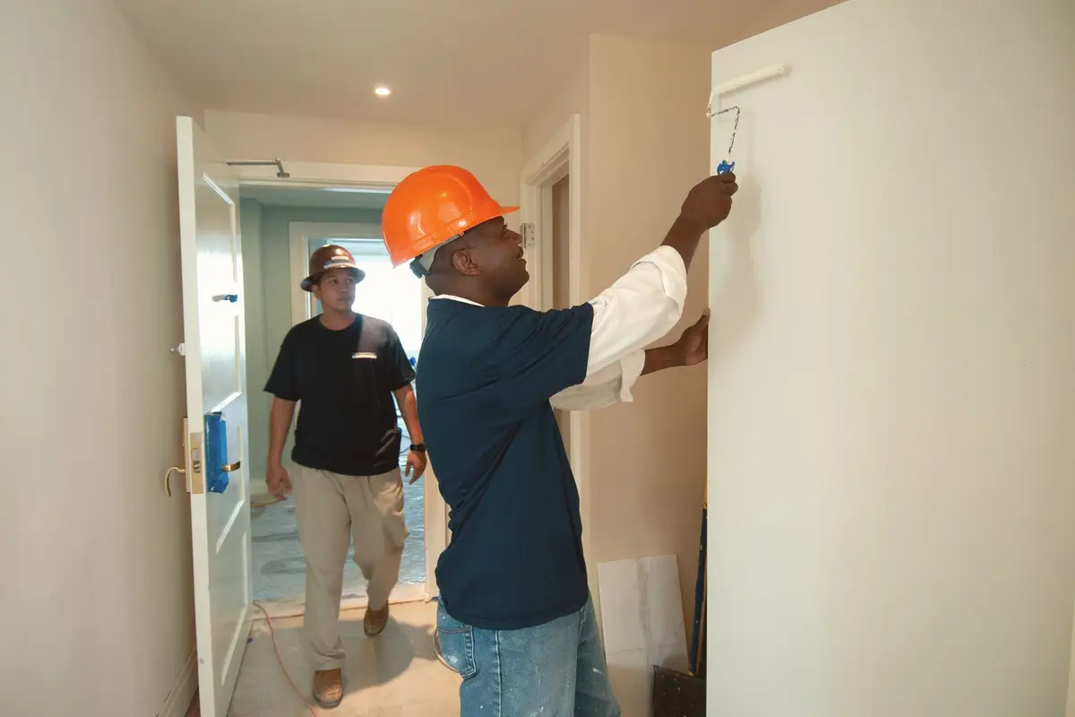 Painters finishing an interior wall in Kyle, TX